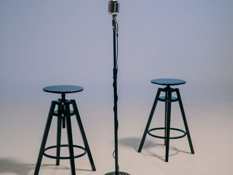 two stools around a microphone set up for interview