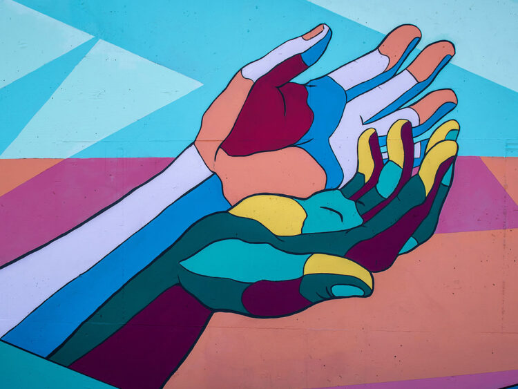 colorful painting of hands together