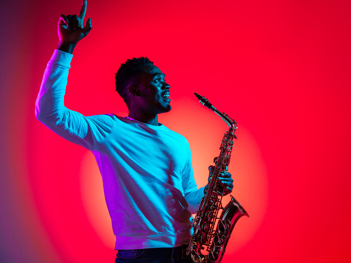 man holding a saxophone 