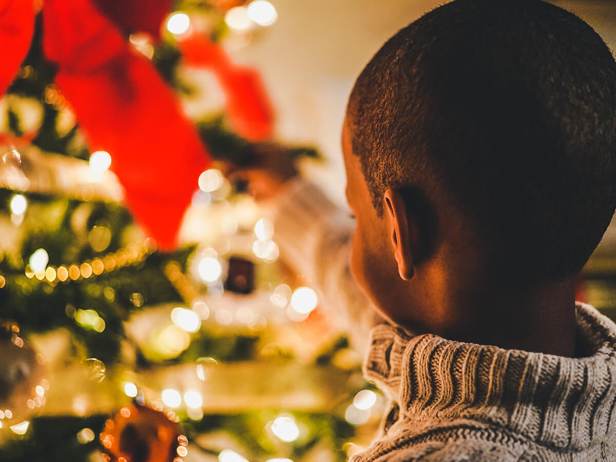 Boy decorating a Christmas tree