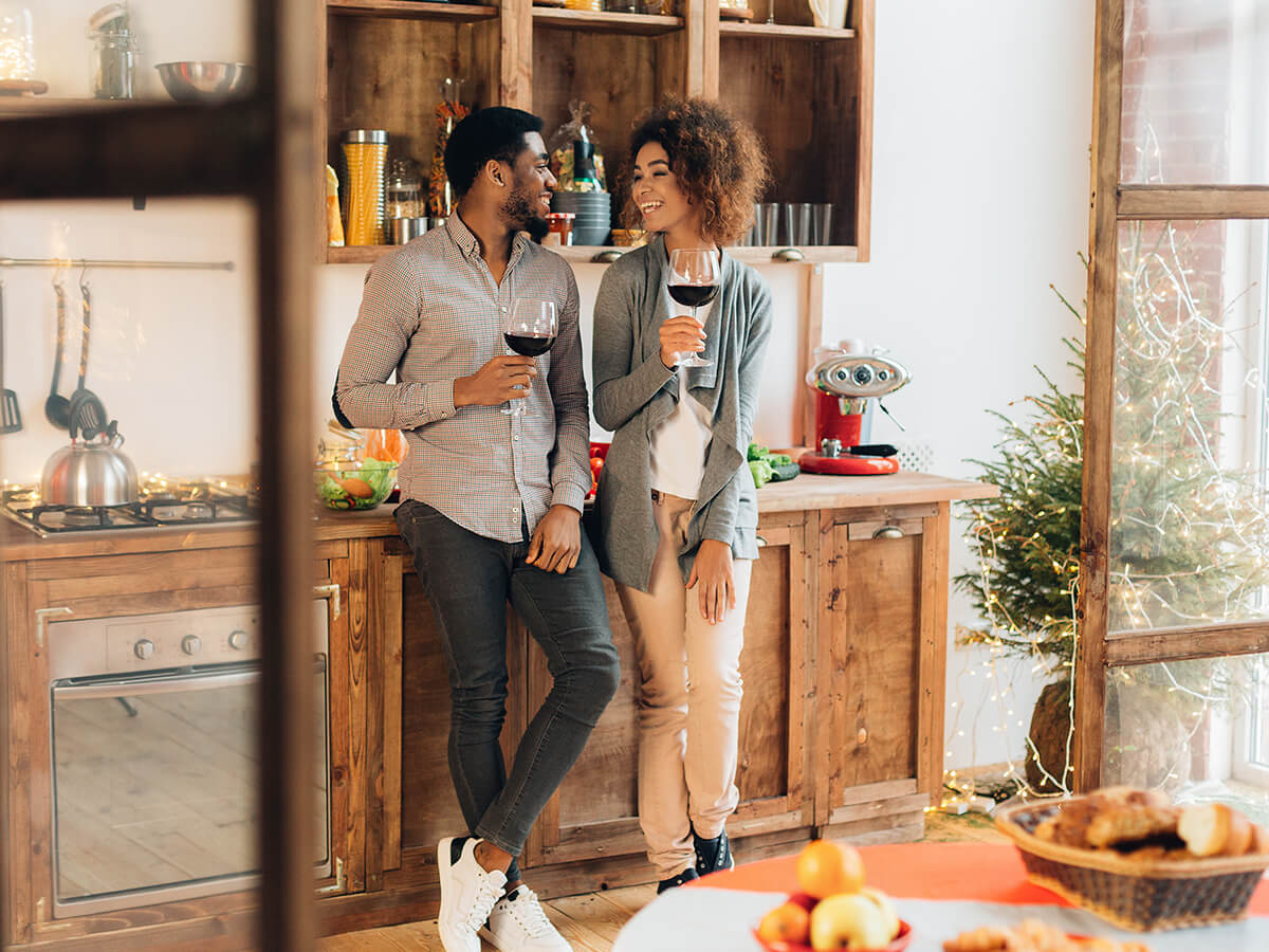 Couple talking in a kitchen decorated for the holidays